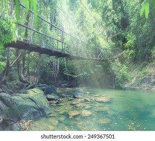 Rope Bridge Over A River In The Jungle