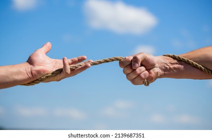 Rope, Cord. Hand Holding A Rope, Climbing Rope, Strength And Determination. Rescue, Help, Helping Gesture Or Hands. Conflict Tug Of War.