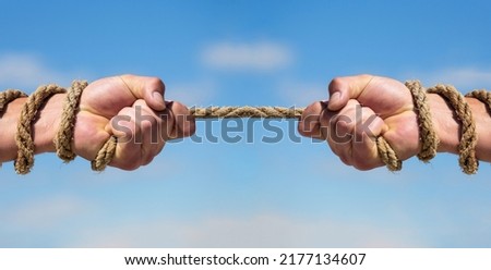 Rope, cord. Hand holding a rope, climbing rope, strength and determination. Rescue, help, helping gesture or hands. Conflict tug of war. Two hands, helping hand, arm, friendship.