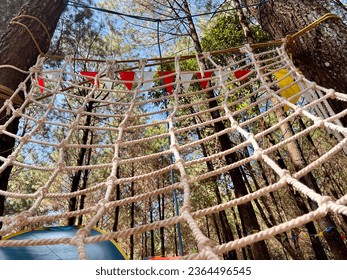 a rope ladder provided for children to play at a campsite - Shutterstock ID 2364496545