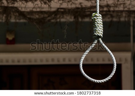 Rope loop or gallows on a dark background.