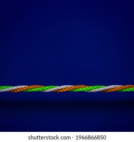 A rope made with Indian tricolors- orange, green and white strings. A metaphor for unity and communal harmony in India. - Powered by Shutterstock