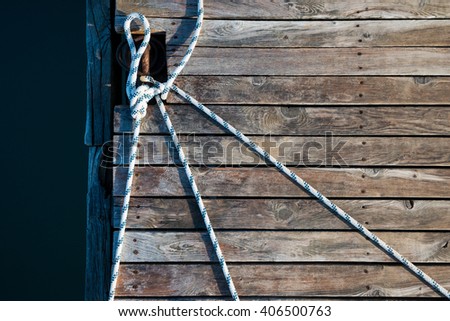 rope and old boards background on the pier in the bay