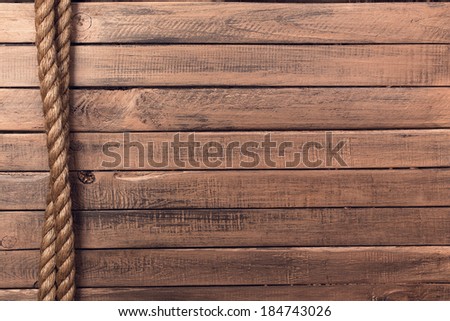 Rope on old wooden board background vertical