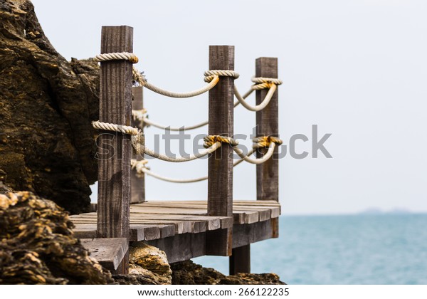 rope on wooden\
bridge walk path at stone\
cliff