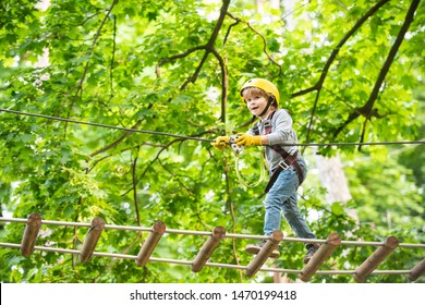 Rope park - climbing center. Child boy having fun at adventure park. Go Ape Adventure. Child boy having fun at adventure park.