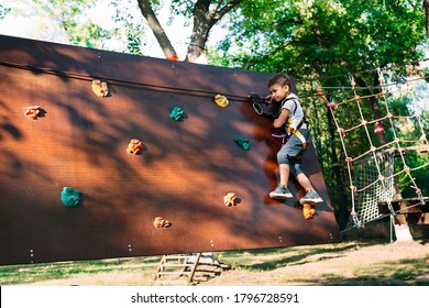 Rope Park. The kid passes the obstacle in the rope Park - Powered by Shutterstock