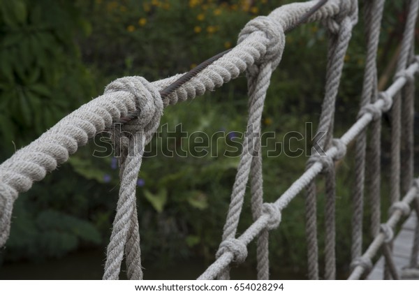 Rope with tied knot of\
a hanging bridge