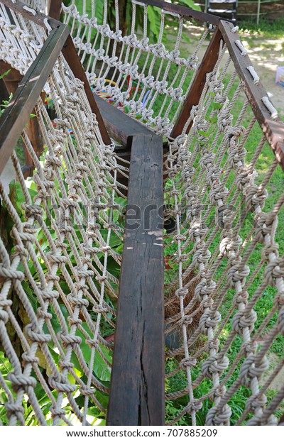Rope and walk bridge with side rope protection
on handrails