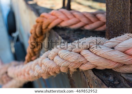 Ropes on Old Rusty Ship Closeup. Old Frayed Boat Rope as a Nautical Background. Naval Ropes on a Pier. Vintage Nautical Knots. Big Marine Sea Ship Ropes.