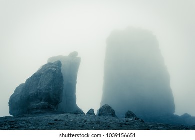 Roque Nublo Big Rock Mountain Covered With Heavy Fog In Gran Canaria, Spain. Futuristic Sci Fi Landscape Setting. Thriller, Mysterious Empty Space. Blue Effect