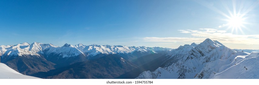 Rosa Khutor ski resort. Mountain landscape of Krasnaya Polyana and sun shining, Sochi - Shutterstock ID 1594755784