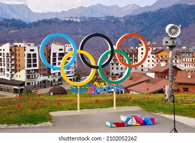 Rosa Khutor, Sochi, Russia, 11.01.2021. Olympic Village In The Mountains. Olympic Rings With A Poster 