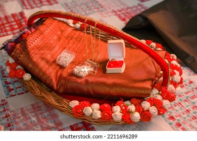 Rosaries And Wedding Rings Decorated On A Red Wedding Saree During A Kerala Catholic Wedding