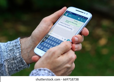 ROSARIO, ARGENTINA - JANUARY 19, 2017: Man With Smartphone In His Hands And A Whatsapp Conversation On The Screen. Young Man, Millennial, Chatting. Technology. Communications.