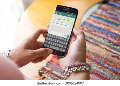 ROSARIO, ARGENTINA - JANUARY 21, 2018: Girl With Smartphone In Her Hands And A Whatsapp Conversation On The Screen. Young Woman, Millennial, Chatting. Technology. Communications.
