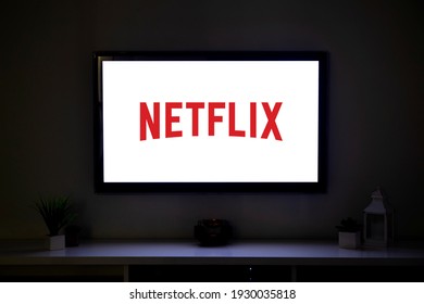 ROSARIO, ARGENTINA - MARCH 4, 2021: Netflix logo on the screen of LCD Smart TV in the middle of a living room of a family home.