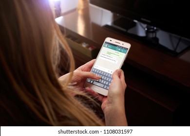 ROSARIO, ARGENTINA - MAY 30, 2018: Girl With Smartphone In Her Hands And A Whatsapp Conversation On The Screen. Young Woman, Millennial, Chatting. Technology. Communications.