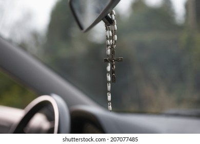 Rosary Beads Hanging In Car