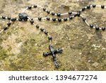 Rosary beads left on a stone