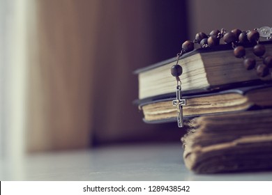 The Rosary Beads On Catholic Church Liturgy Books.