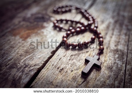 Rosary beads and religious crucifix cross with copy space background