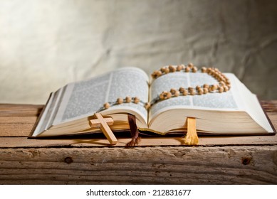 rosary with bible on the desk