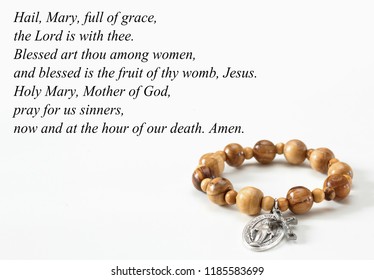 Rosary Bracelet On White With Hail Mary Prayer.