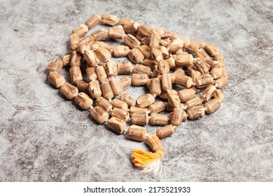 Rosary Or Prayer Beads On A Dark Background.