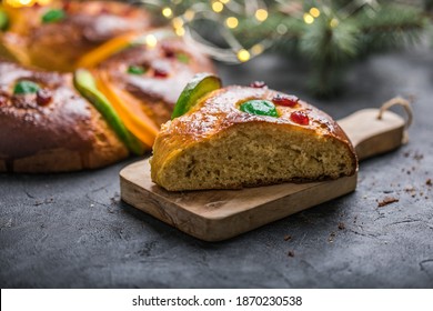 Rosca de reyes, spanish three kings cake eaten on epiphany day, on a gray rustic table