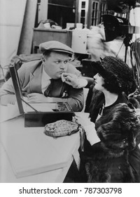 Roscoe Fatty Arbuckle, American Actor, Getting Touch Up By Make Up Girl On Movie Set, C. 1920. Arbuckle Was One Of The Most Popular Silent Stars Of The 1910s. In 1920 He Signed A Contract With Paramou