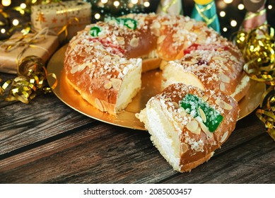 Roscon De Reyes With Cream And Christmas Ornaments On A Table. Kings Day Concept Spanish Three Kings Cake.Typical Spanish Dessert For Christmas. Selective Focus