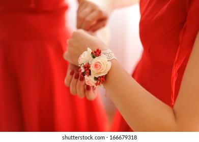 rose boutonniere with lace ribbon on bridesmaid's hand