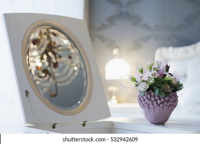 The Rose Bowl In The Bedroom On A Table Near The Mirror.
