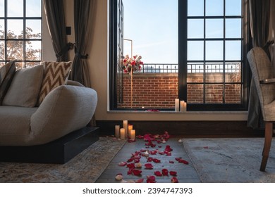 Rose petals and lit candles on the floor lead to a romantic set up out on the red brick terrace. - Powered by Shutterstock