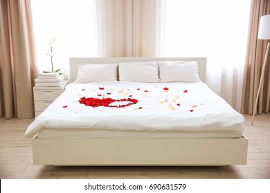 Rose Petals On Bed In Hotel Room