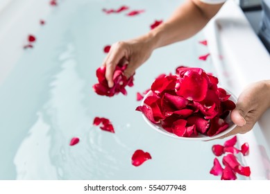 Rose petals put in bathtub for romantic bathroom in honeymoon suit.Arranged by interior designer for honeymoon couple. Scent of rose make relax. Spa shop put flowers in the tub with towels for lover. - Powered by Shutterstock