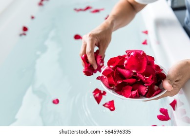 Rose petals put in bathtub for romantic bathroom in honeymoon suit.Arranged by interior designer for honeymoon couple. Scent of rose make relax. Spa shop put flowers in the tub with towels for lover. - Powered by Shutterstock