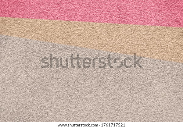 Rose pink and earth tone colors of\
cement wall background texture divided into three parts. Surface of\
concrete texture in 3 tone background\
colors.