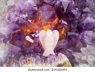 Rose Quartz Angel Shape Against Amethyst Geode Indoors, Studio Shot. Guardian Angel Concept, Copy Space.