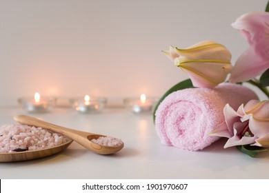 Rose sea salt, candles, towels and lily flower