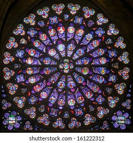 Rose stained glass window of Notre Dame Cathedral, inside view. Pattern of old South rose window, medieval Gothic rose window close-up, luxury interior detail of Catholic church. Paris - Sep 25, 2013