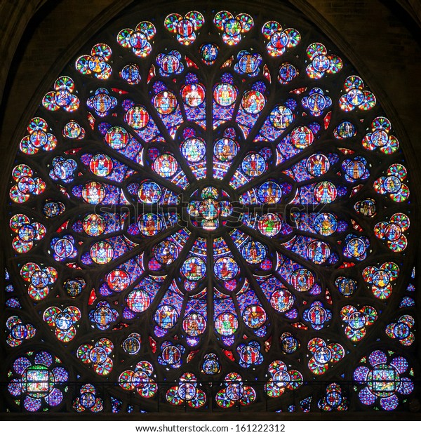 Rose stained glass window of Notre Dame Cathedral,\
inside view. Pattern of old South rose window, medieval Gothic rose\
window close-up, luxury interior detail of Catholic church. Paris -\
Sep 25, 2013