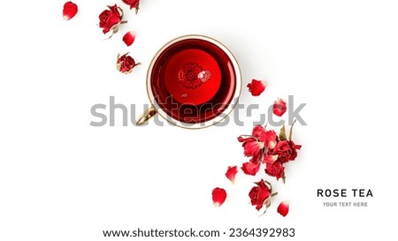 Healthy summer roses tea in cup with red roses petals, top view. Copy space