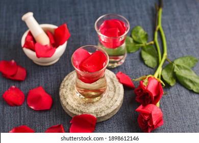 Rose Water With Rose Petals Indian Red Rose Flower. Making Organic Rose Essence For Cooking Kerala India. Essential Oil Aromatherapy Skincare, Spa Relaxation, Treatment, Organic Cosmetics Concept.