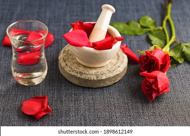 Rose Water With Rose Petals Indian Red Rose Flower. Making Organic Rose Essence For Cooking Kerala India. Essential Oil Aromatherapy Skincare, Spa Relaxation, Treatment, Organic Cosmetics Concept.