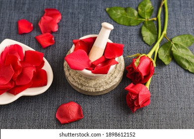 Rose Water With Rose Petals Indian Red Rose Flower. Making Organic Rose Essence For Cooking Kerala India. Essential Oil Aromatherapy Skincare, Spa Relaxation, Treatment, Organic Cosmetics Concept.