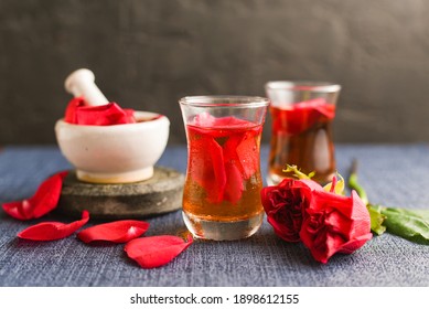 Rose Water With Rose Petals Indian Red Rose Flower. Making Organic Rose Essence For Cooking Kerala India. Essential Oil Aromatherapy Skincare, Spa Relaxation, Treatment, Organic Cosmetics Concept.