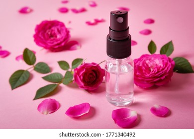 Rose Water Spray With Pink Fresh Flowers And Petals On Pink Background