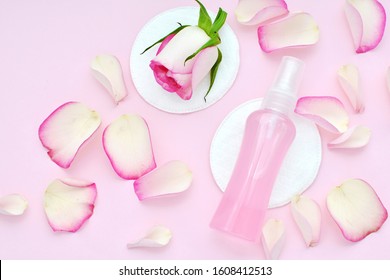 Rose Water Spray, Roses Petals, Cosmetic Pads, Facial Toner, Make Up Remover, Beauty, Skin Care Flat Lay On Pink Background.